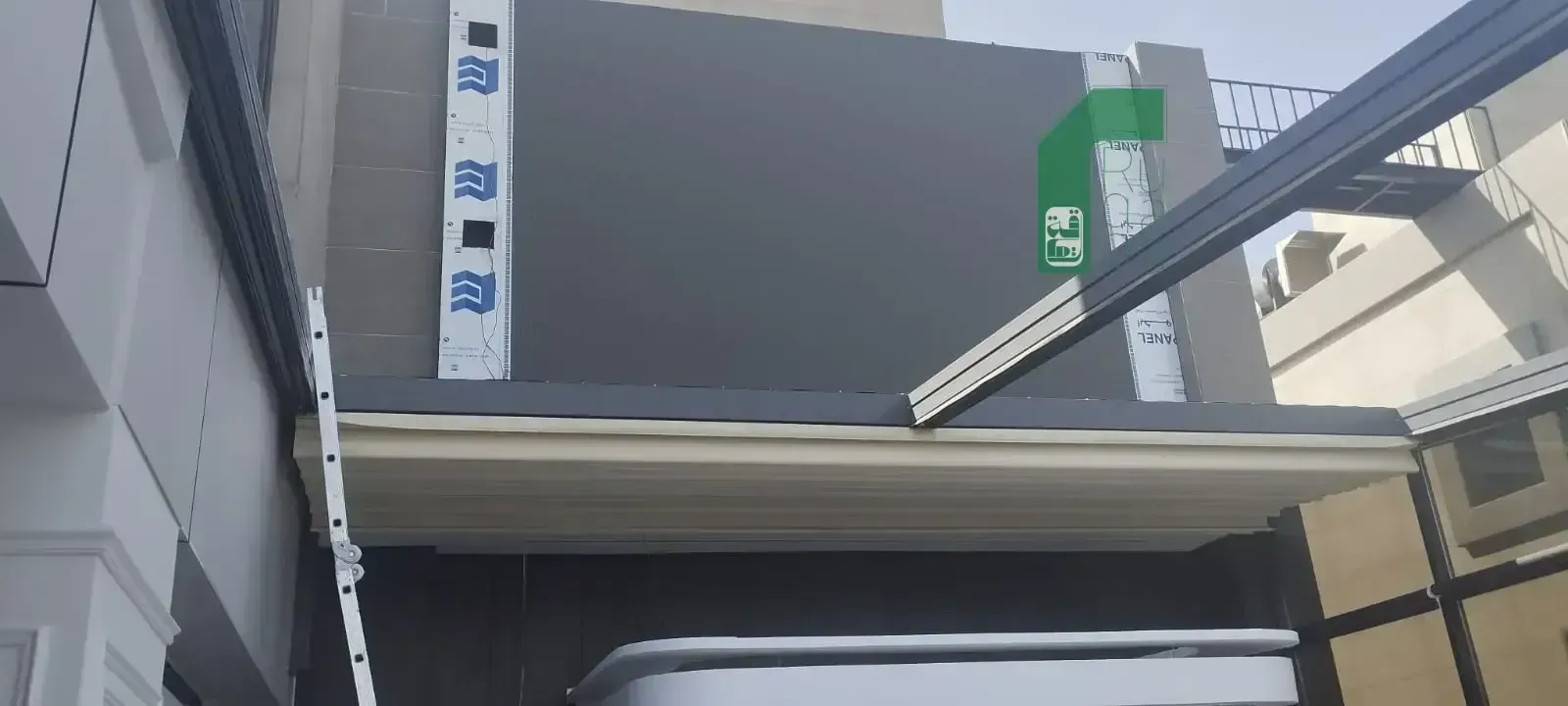 Ruqaqa outdoor flat LED screen mounted on a building façade during installation
