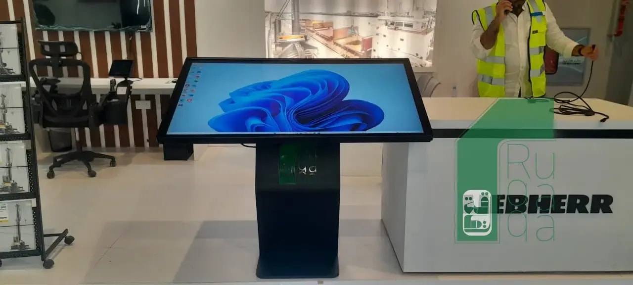 Ruqaqa interactive kiosk with branded touchscreen display installed at exhibition showcasing the client's solutions